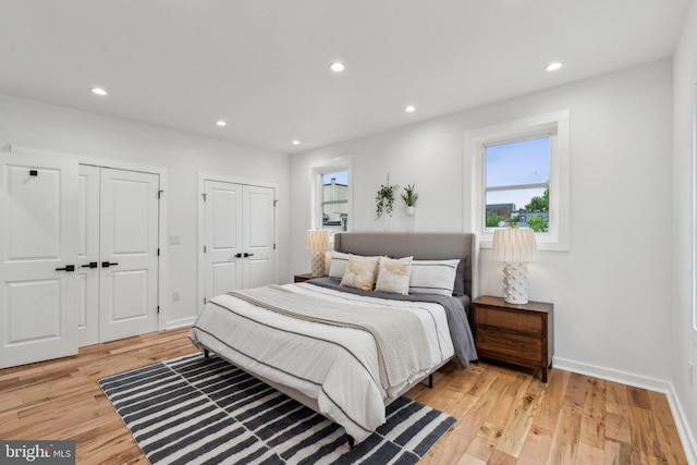 660 Columbia Rd NW, Washington, DC 20001 - bedroom featuring multiple closets, light wood finished floors, recessed lighting, and baseboards