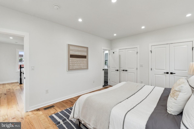 660 Columbia Rd NW, Washington, DC 20001 - bedroom with multiple closets, light wood-style flooring, recessed lighting, and baseboards