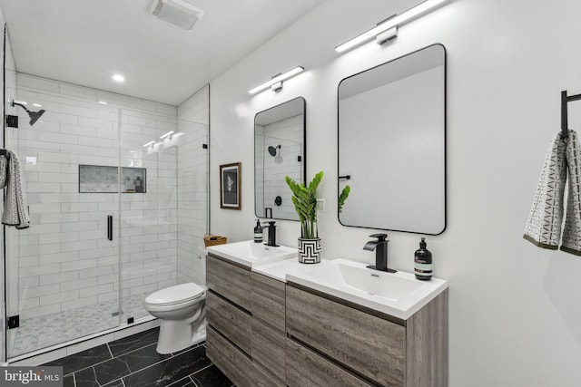 660 Columbia Rd NW, Washington, DC 20001 - bathroom with marble finish floors, a stall shower, double vanity, and toilet