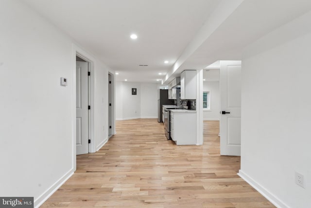660 Columbia Rd NW, Washington, DC 20001 - kitchen featuring recessed lighting, white cabinets, light wood-style floors, baseboards, and freestanding refrigerator