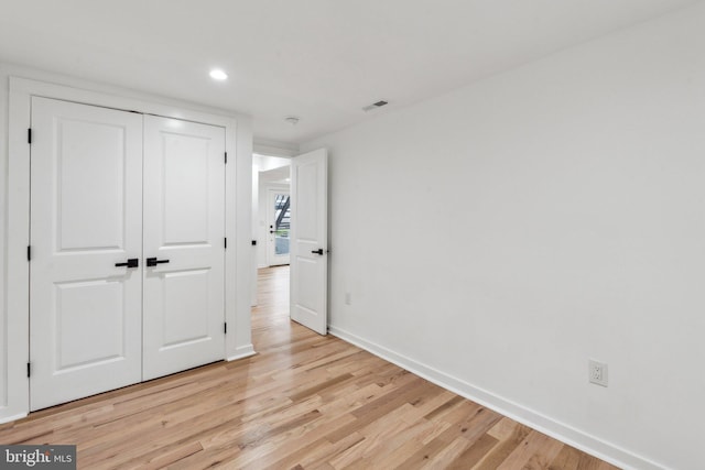 660 Columbia Rd NW, Washington, DC 20001 - unfurnished bedroom with light wood finished floors, baseboards, recessed lighting, and a closet