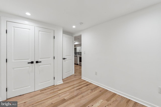 660 Columbia Rd NW, Washington, DC 20001 - unfurnished bedroom with light wood finished floors, baseboards, a closet, and recessed lighting