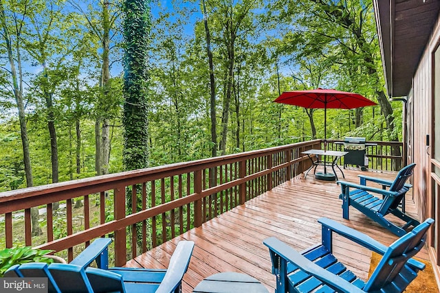 wooden terrace featuring area for grilling