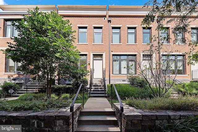 multi unit property with stairs and brick siding