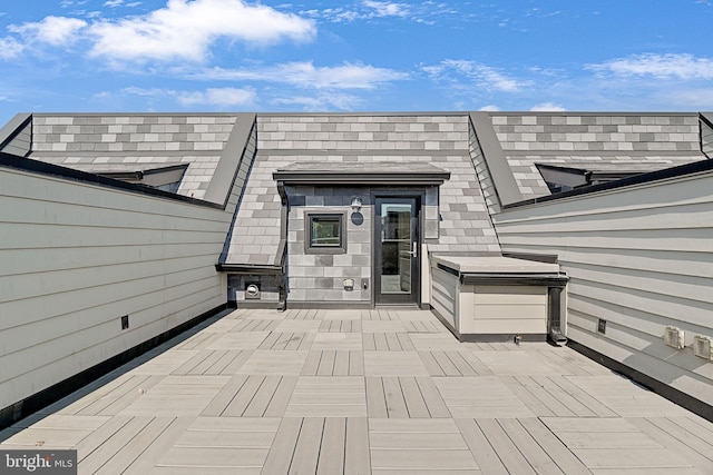 entrance to property featuring a wooden deck