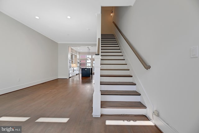 stairs featuring french doors, recessed lighting, baseboards, crown molding, and wood finished floors