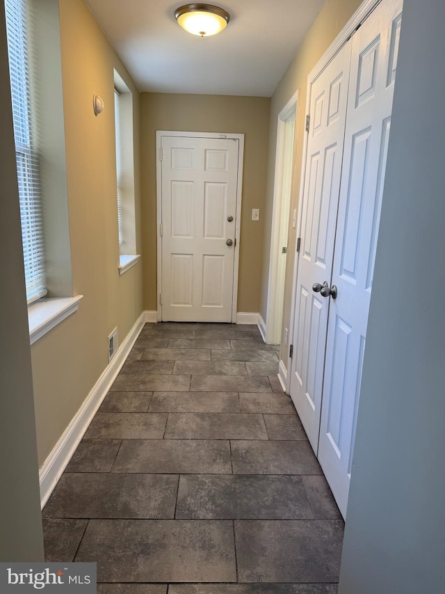 entryway featuring baseboards