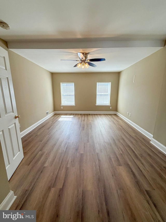 spare room featuring ceiling fan, baseboards, wood finished floors, and a smoke detector