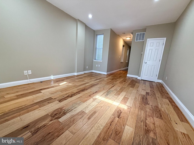 spare room with light wood-style flooring, baseboards, and recessed lighting