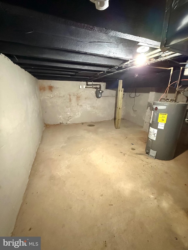 unfinished basement featuring water heater