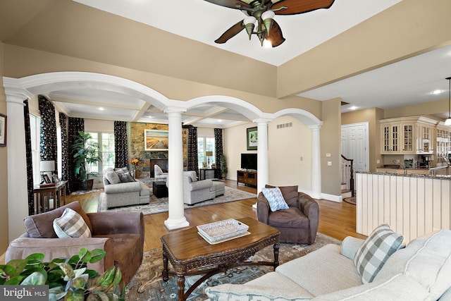 107 Centrenest Ln, Wilmington, DE 19807 - living room featuring coffered ceiling, ceiling fan, arched walkways, light wood-type flooring, and ornate columns