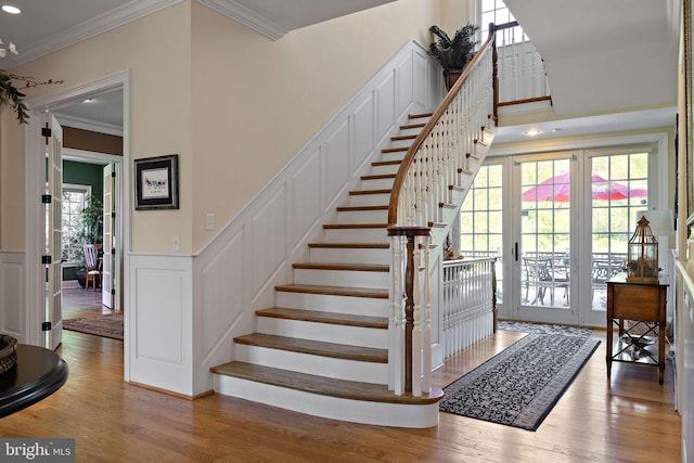 107 Centrenest Ln, Wilmington, DE 19807 - stairs featuring crown molding, plenty of natural light, a decorative wall, and wood finished floors