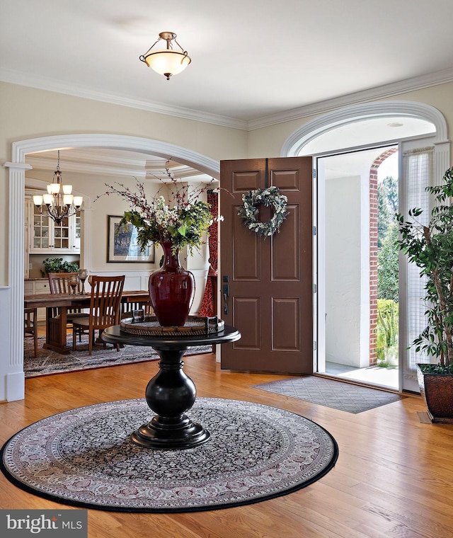 107 Centrenest Ln, Wilmington, DE 19807 - foyer featuring arched walkways, ornamental molding, a chandelier, and wood finished floors