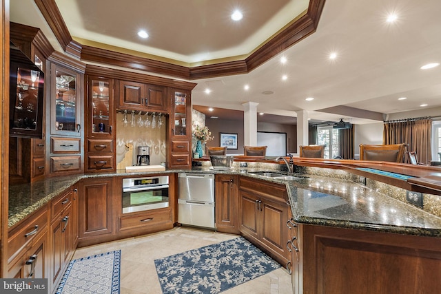 107 Centrenest Ln, Wilmington, DE 19807 - kitchen featuring a sink, a peninsula, stainless steel appliances, ornate columns, and a raised ceiling