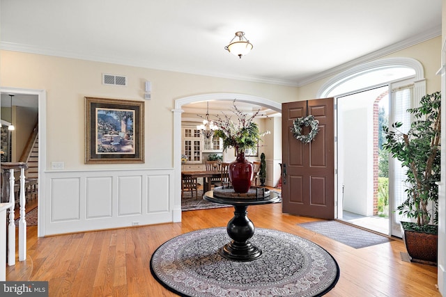 107 Centrenest Ln, Wilmington, DE 19807 - foyer entrance with an inviting chandelier, visible vents, crown molding, arched walkways, and stairway
