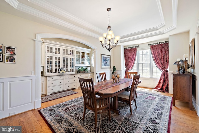 107 Centrenest Ln, Wilmington, DE 19807 - dining room featuring a tray ceiling, ornamental molding, light wood finished floors, wainscoting, and a chandelier