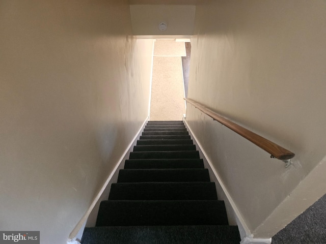 staircase with carpet and baseboards