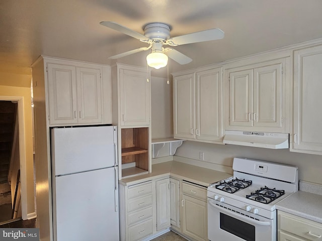 kitchen with white appliances, under cabinet range hood, light countertops, a ceiling fan, and white cabinets