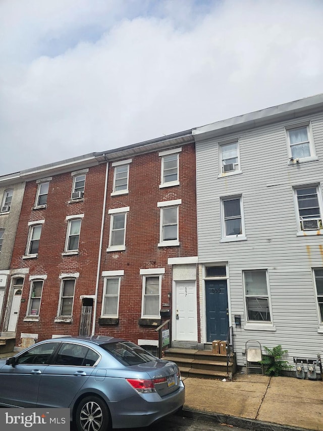 view of property featuring cooling unit and entry steps