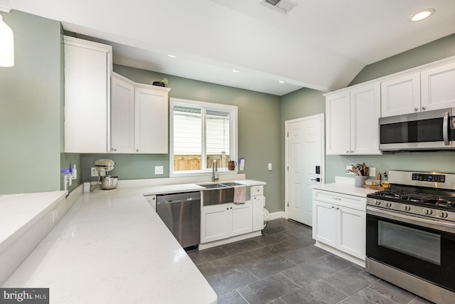 kitchen featuring recessed lighting, visible vents, a sink, white cabinetry, and stainless steel appliances