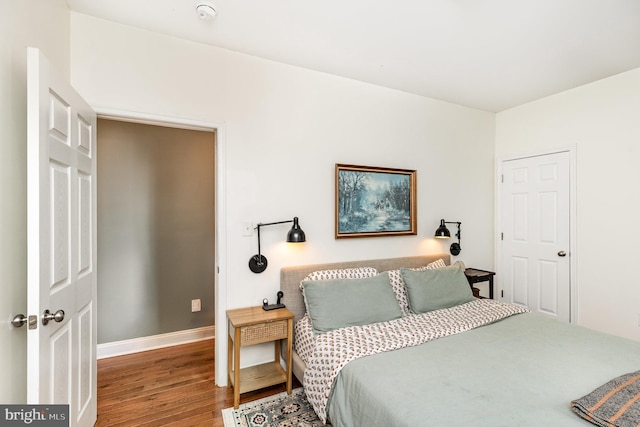 bedroom with wood finished floors and baseboards