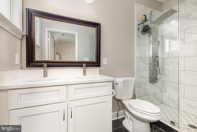 full bathroom with a shower stall, toilet, and a sink