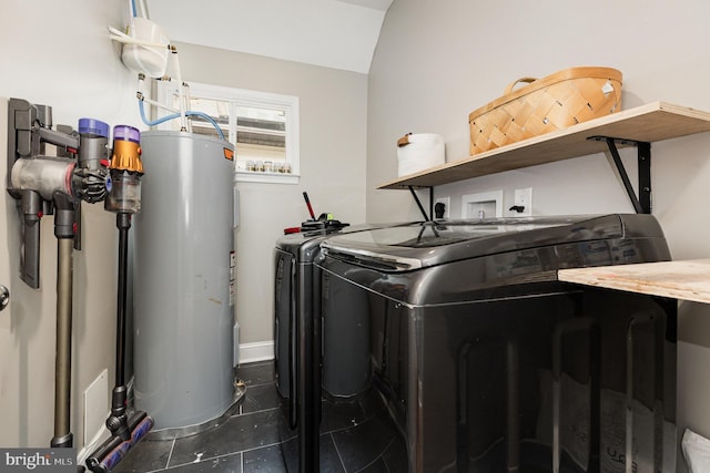laundry room featuring washer and dryer, laundry area, tile patterned floors, water heater, and baseboards