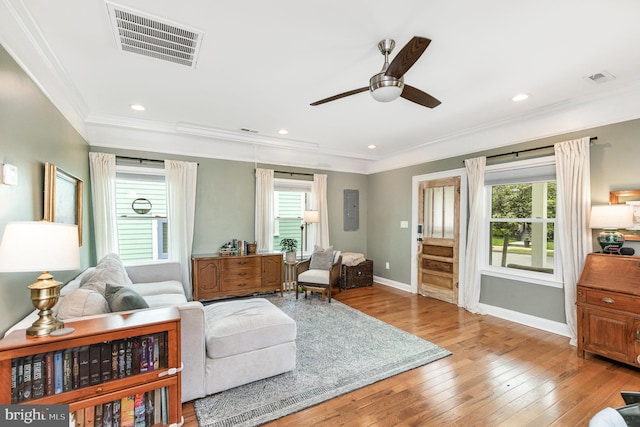 living area featuring visible vents, baseboards, a ceiling fan, and hardwood / wood-style floors