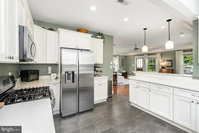 kitchen with light countertops, stainless steel appliances, visible vents, and plenty of natural light