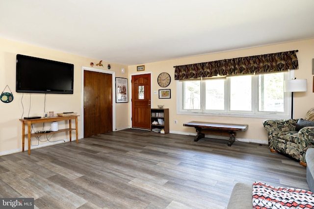 living area with wood finished floors and baseboards