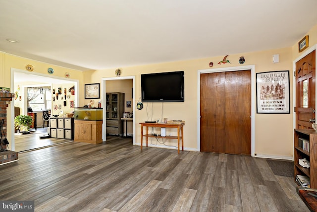 living room with dark wood finished floors and baseboards