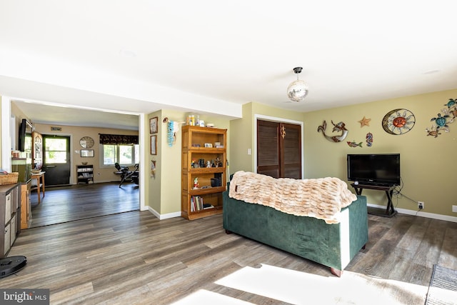 living room featuring dark wood finished floors and baseboards
