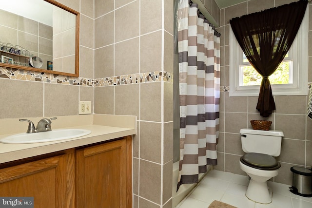 bathroom with tile walls, vanity, a shower with shower curtain, toilet, and tile patterned flooring