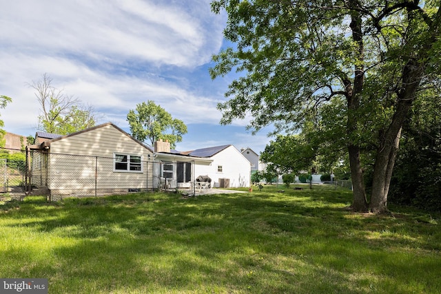 back of property featuring a chimney and a patio area