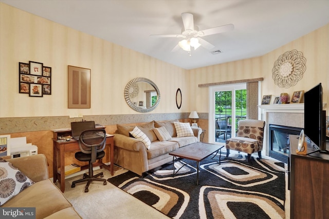 3114 Harmony Rose Ct, Dover, PA 17315 - living room featuring wallpapered walls, carpet flooring, a ceiling fan, and a glass covered fireplace