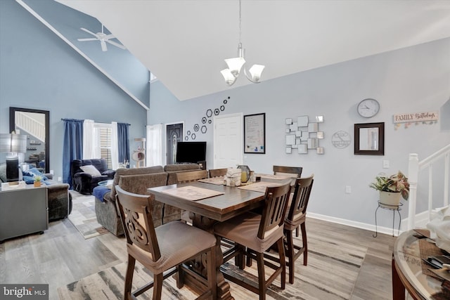 3114 Harmony Rose Ct, Dover, PA 17315 - dining area featuring light wood-style flooring, high vaulted ceiling, stairs, a chandelier, and ceiling fan