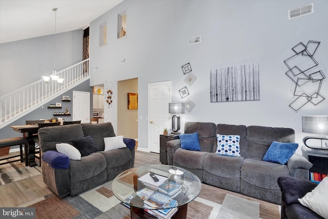 3114 Harmony Rose Ct, Dover, PA 17315 - living area with stairs, high vaulted ceiling, wood finished floors, a chandelier, and baseboards