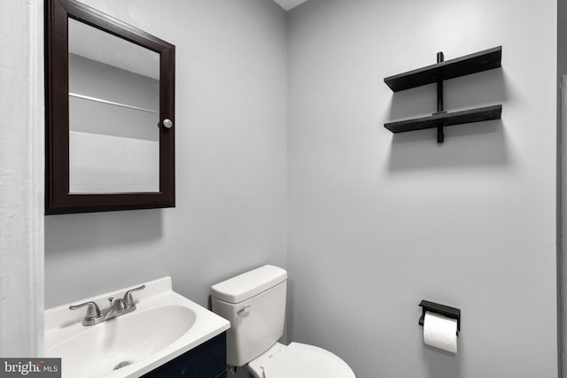 bathroom featuring toilet and vanity