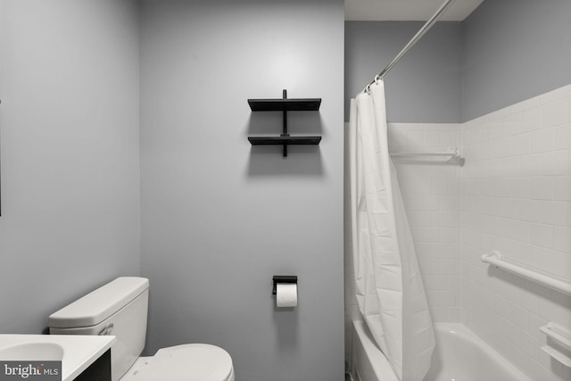 bathroom with shower / bath combo, toilet, and vanity
