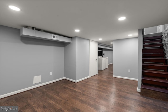 finished below grade area featuring separate washer and dryer, stairway, baseboards, wood finished floors, and recessed lighting