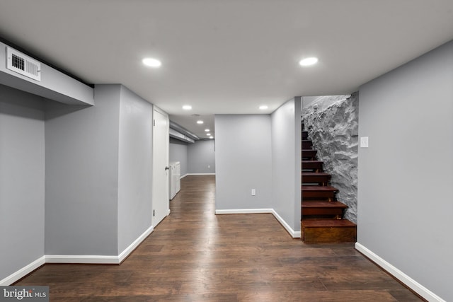 finished basement with recessed lighting, dark wood finished floors, stairs, and baseboards