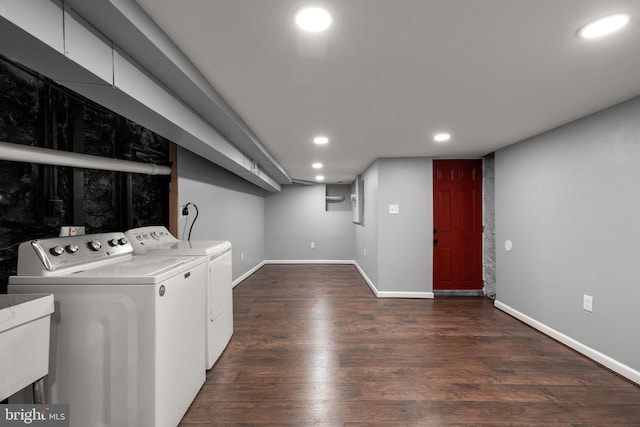 laundry area featuring washing machine and dryer, dark wood-type flooring, recessed lighting, and baseboards