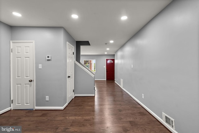 foyer featuring wood finished floors, recessed lighting, and baseboards