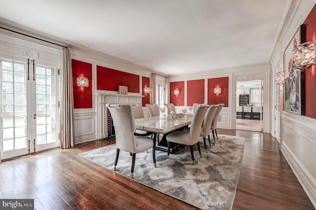 dining area with crown molding, plenty of natural light, and a decorative wall