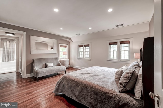 bedroom featuring baseboards, recessed lighting, visible vents, and wood finished floors