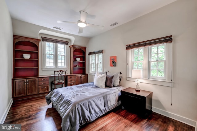bedroom with baseboards, a ceiling fan, visible vents, and dark wood-style floors