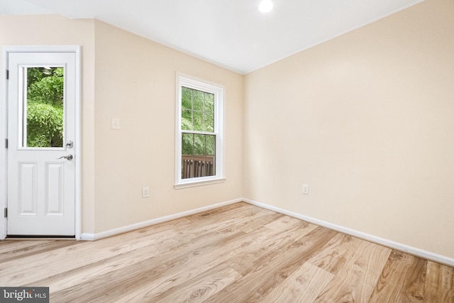 interior space featuring recessed lighting, baseboards, and wood finished floors