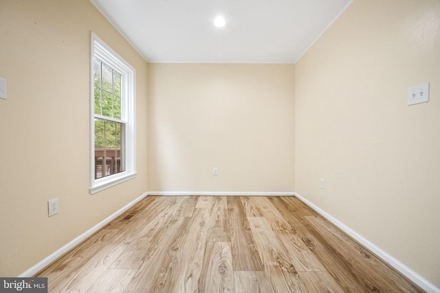 unfurnished room with wood finished floors and baseboards
