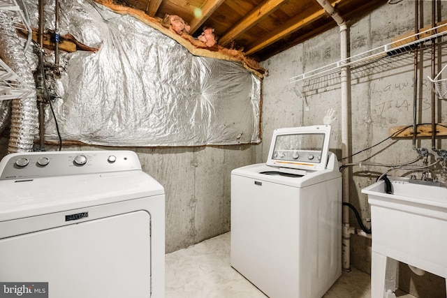 washroom featuring laundry area, independent washer and dryer, and a sink