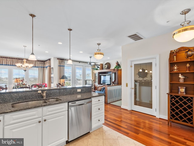 13000 Marina View Ln Unit 25, Ocean City, MD 21842 - kitchen with dishwasher, a sink, white cabinets, pendant lighting, and dark stone counters